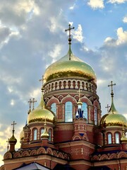 the Orthodox church in Orenburg glitters with a golden roof at sunset