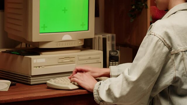 Retro PC with croma key green screen, Using vintage old computer. Dvd player, disc drive. Music recorder, playing retro computer games. 