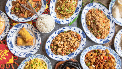 Table Full of Food: An image capturing a bountiful spread of various dishes arranged on a table, showcasing a diverse assortment of cuisines and flavors, ideal for feasts or banquets.