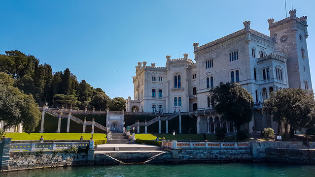 Scenic view of majestic historic white Miramare castle in Trieste in Friuli-Venezia Giulia, Italy, Europe. Blue sky in tranquil atmosphere at Adriatic Mediterranean sea in summer. Sightseeing