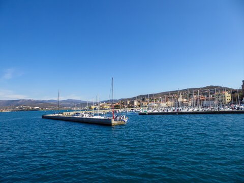 Scenic view from a ferry of the port of Trieste from in Friuli-Venezia Giulia, Italy, Europe. Blue sky in tranquil atmosphere at Adriatic Mediterranean sea in summer. Boat tour along the coastline