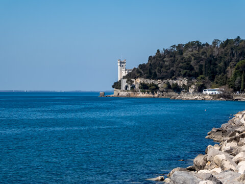 Scenic view of majestic historic white Miramare castle in Trieste in Friuli-Venezia Giulia, Italy, Europe. Blue sky in tranquil atmosphere at Adriatic Mediterranean sea in summer. Sightseeing