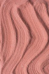 Lines drawn in coral sand background, beautiful sand texture, overhead view of brick orange sand, zen pattern drawn in the sand, Top view of fine grain texture