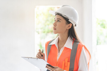 Building inspection asian contractor young woman inspecting home, reconstructed construction,...