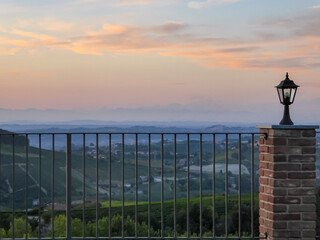 Watching sunset from private terrace on remote vineyard in Langhe wine region of Piedmont...