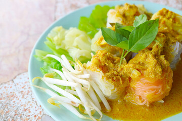 Delectable Thai Dish of Khanom Chin Nam Ya Poo, a Rice Vermicelli Served with Spicy Crab Meat Yellow Curry and Assorted Vegetables