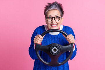 Photo of concentrated focused funny woman wear stylish clothes hold steering wheel drive firts time...