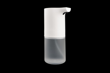 Modern automatic soap dispenser isolated on black background. Sensor soap dispenser