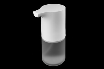 Modern automatic soap dispenser isolated on black background. Sensor soap dispenser