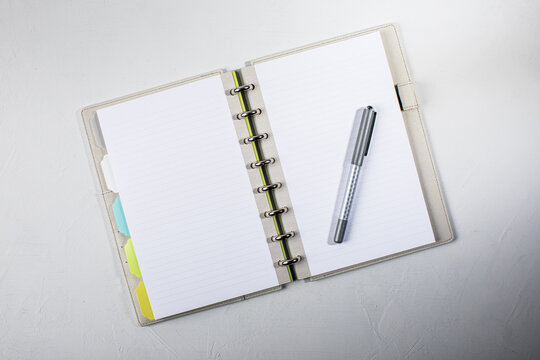 Open lined notebook with pen