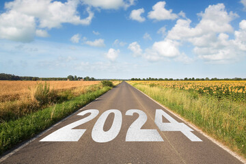 New Year 2024 upcoming, new beginnings, hope and opportunities reflecting the aspirations and dreams - Concept with road in a rural scene