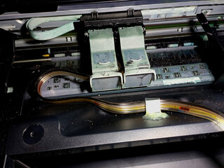 The printer cover is open and the cartridges on the print carriage are extended. The internal...