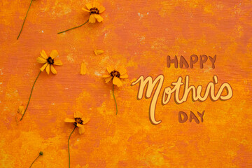 Happy Mothers Day background design with bright cheerful orange color by flowers.