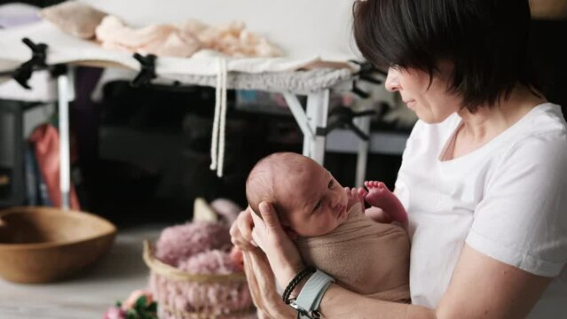 Professional Baby Photographer In Photo Studio With Newborn
