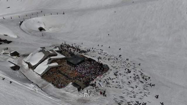 Aerial drone view of people enjoying apres-ski.  Apres ski in a mountain chalet bar in les deux alpes. People dancing in a mountain bar in the ski resort of Les 2 Alpes, France.  Apres ski in alps