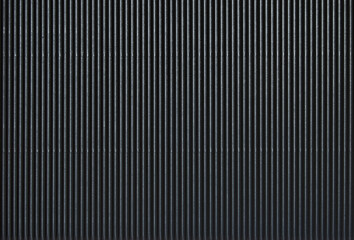 A sheet of black glossy corrugated cardboard texture as background