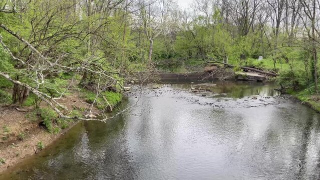 First person point of view of observing West Hickman creek from rusted pedestrian bridge in Veterans park, Lexington, Kentucky