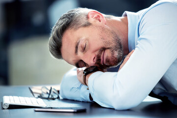 Businessman, tired and sleeping with desk in office with exhausted from overworked in company....