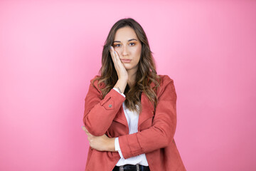 Young beautiful woman wearing casual jacket over isolated pink background thinking looking tired...