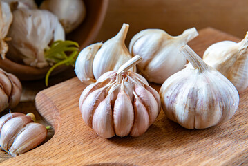Organic garlic on wooden cutting board. Food background.