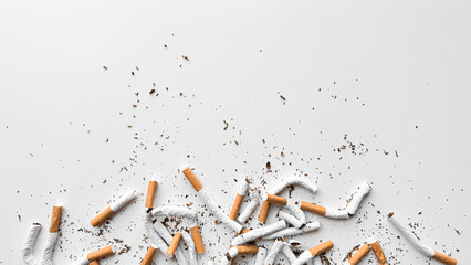 Discarded crushed broken cigarettes and scattered tobacco on white background, representing cessation and the end of smoking with copy space. No tobacco day. - Powered by Adobe