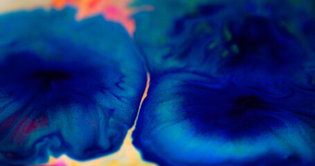 Ink blot. Shiny fluid drip. Defocused blue color sparkling glitter particles water dye paint liquid spill acrylic stain in flower shape abstract art background.