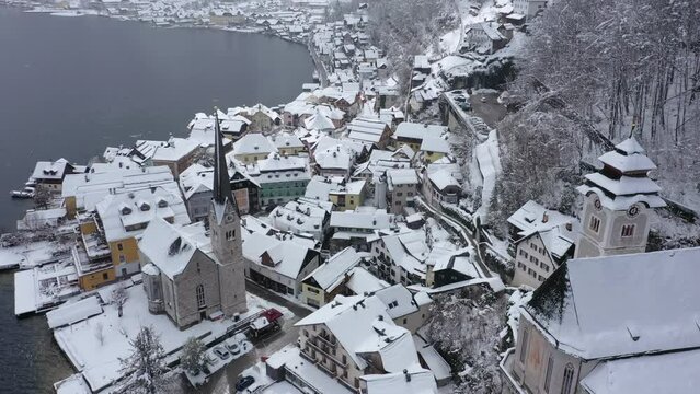 Aerial video of Hallstatt city cover by snow, Austria.