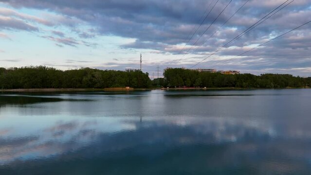 Drone footage reveals a peaceful lake nestled among urban towers. Petrzalka jazero draždiak.