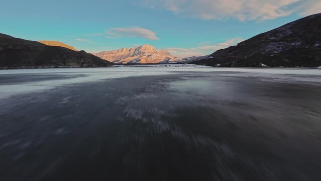 quick FPV drone flight over a frozen lake