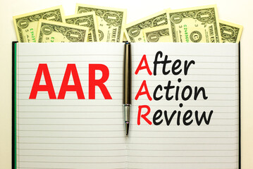 Fototapeta premium AAR After action review symbol. Concept words AAR After action review on beautiful white note. Dollar bills. Beautiful dollar bills background. Business AAR after action review concept. Copy space.