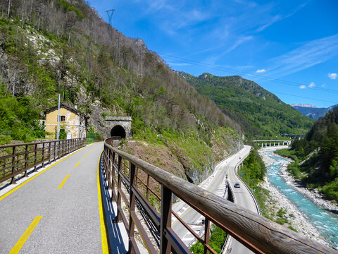 Ciclovia Alpe Adria bike lane entering one of the many tunnels on the route, Val Canale valley, Udine, Friuli Venezia-Giulia, Italy, Europe. Bike trail along the old train tracks through wilderness