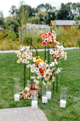 A collection of vases filled with flowers on grass field