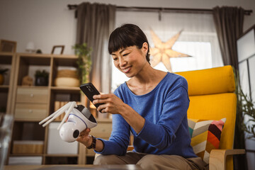 mature japanese woman adjust prepare home surveillance security camera