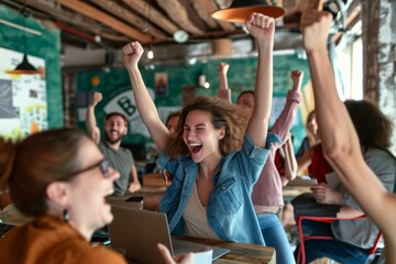 Cheerful young woman with raised hands is celebrating success in cafe.