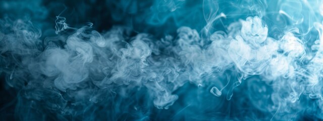 Artificial smoke in blue light in darkness, abstract background
