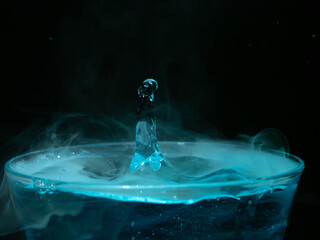 Water drop closeups while drops falling down and splashing into water with smoke in Jena