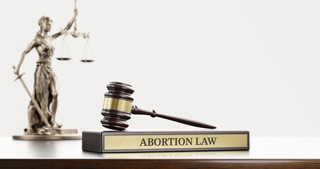 Abortion law: Judge's Gavel as a symbol of legal system, Themis is the goddess of justice and wooden stand with text word