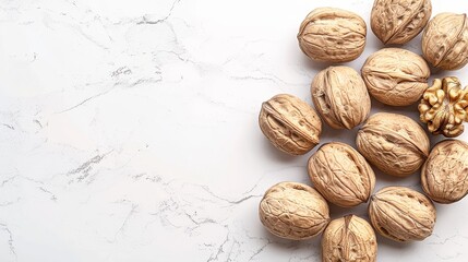   A nut pile on a white counter, near a wooden nut dispenser - obrazy, fototapety, plakaty