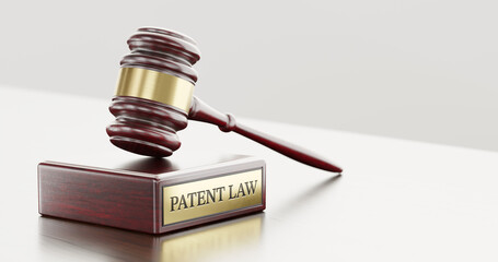 Patent Law: Judge's Gavel as a symbol of legal system and wooden stand with text word