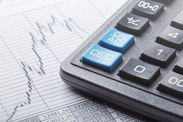 calculator and financial charts. Investment and capital accumulation concept