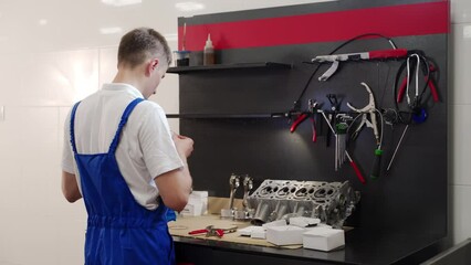 Professional mechanic assembles engine with precision tools, installs pistons, rings, liners in workshop for vehicle maintenance, automotive rebuild, and mechanical education tutorial footage.