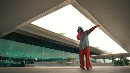 Motion shot of professional hipster listening music while perform freestyle dance. Street dancer...