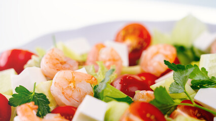 Salad in a Greek shrimp salad. A close-up salad of fresh vegetables, a plate of fresh salad with...