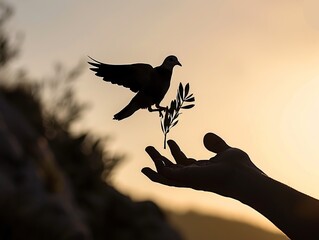 An evocative silhouette portraying a helping hand reaching out towards a dove carrying an olive leaf branch, symbolizing the desire for freedom and peace. International Day of Peace - obrazy, fototapety, plakaty