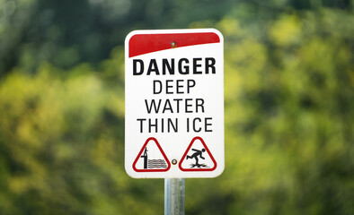 Danger, deep water, thin ice. Warning sign on the lake in Canada
