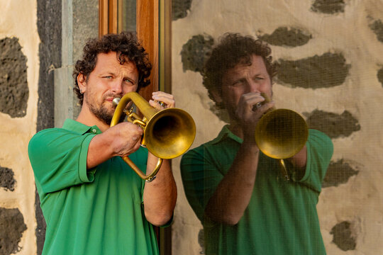 Inspirational one-armed man playing trumpet on the street