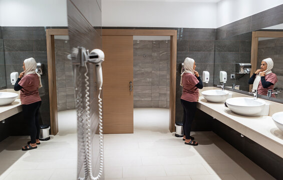 Muslim woman preparing for yoga class in locker room