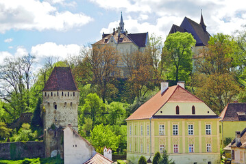 Fototapeta premium View of the architecture in the upper part of the Old Town of Sighisoara from the view of the Clock Tower: the Tinsmiths' Tower, the Church on the Hill, the old school and other buildings