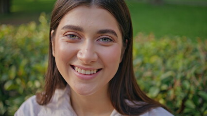 Smiling lady enjoy park leisure looking camera close up. Portrait joyful woman