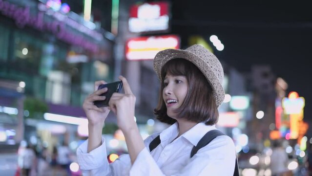 Travel concept of 4k Resolution. Asian woman taking pictures on the street while traveling.